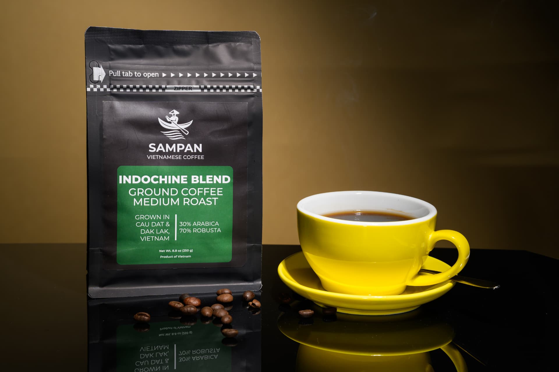 Sampan Indochine Blend coffee bag standing beside a yellow cup of brewed Vietnam